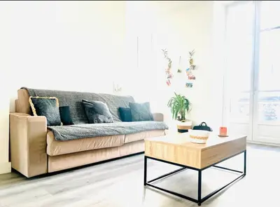 a living room with a couch and a coffee table at Spacieux 4 couchage plein centre in Nice
