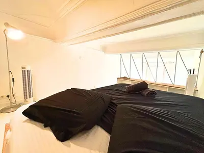 a bedroom with a bed with black sheets and a window at Cosy appart 4pers vieux Nice in Nice