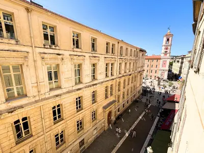 an old building with a clock tower in a city at Cosy appart 4pers vieux Nice in Nice