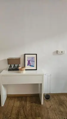a white table with a picture on top of it at 68 m2 central pour des vacances en famille in Nice