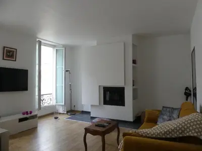 a living room with a couch and a fireplace at 68 m2 central pour des vacances en famille in Nice