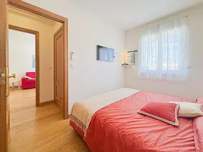 a bedroom with a bed with a red blanket at Suite Zara - wifi, AC, 4 pers in Nice