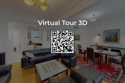 a living room with a couch and a dining room at Bright air-conditioned flat in the city centre in Nice