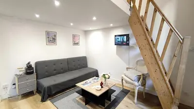 a living room with a couch and a staircase at Appartement port et vieux Nice Direct from Airport by tramway in Nice