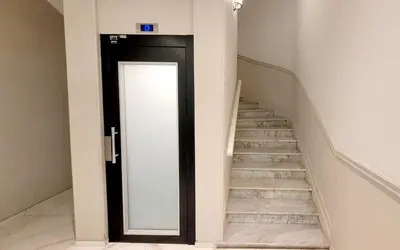 a hallway with a door leading up to a staircase at Ze Perfect Place - Studio centre-ville - Masséna in Nice