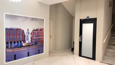 a hallway with a large painting on the wall at Ze Perfect Place - Studio centre-ville - Masséna in Nice