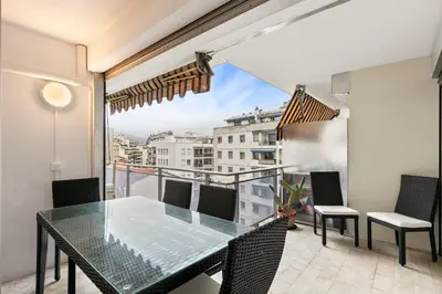 a dining table and chairs on a balcony with a view at Suite Prestige FSHH in Nice
