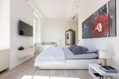 a bedroom with a bed and a bath tub at Le Massena in Nice