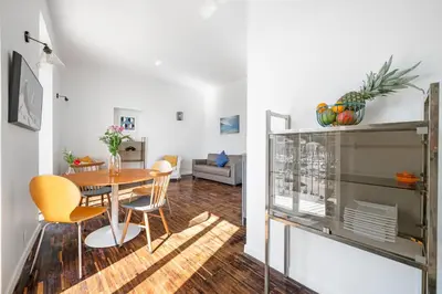 a dining room and living room with a table and chairs at Sunlight Properties - Capitaine 54 - 1 Bedroom, stunning holiday rental apartment with balcony and port view in Nice