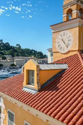 a clock tower on top of a building with a window at Sunlight Properties - Capitaine 54 - 1 Bedroom, stunning holiday rental apartment with balcony and port view in Nice