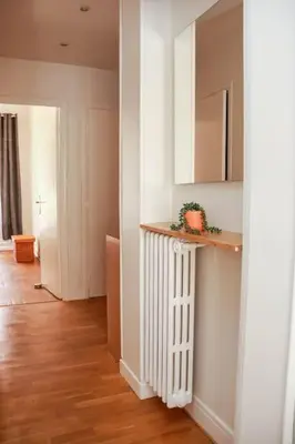 a hallway with a white radiator in a room at Cosy 3 pièces à 5 min de la PROM in Nice