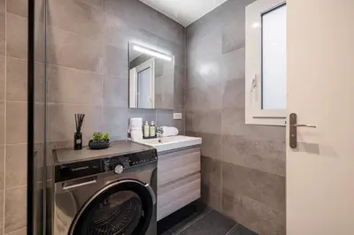 a laundry room with a washer and a sink at Panoramic Sea View - 1 Bdr Promenade des Anglais in Nice