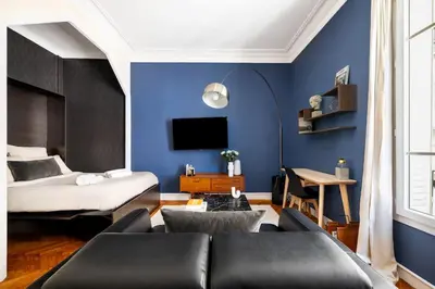 a living room with a bed and a couch at Raffinement en pleine ville in Nice