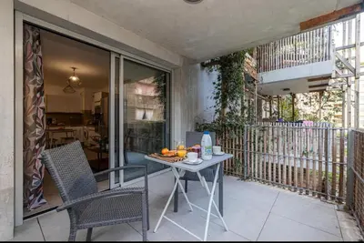 a patio with a table and chairs on a balcony at Appartement nice in Nice
