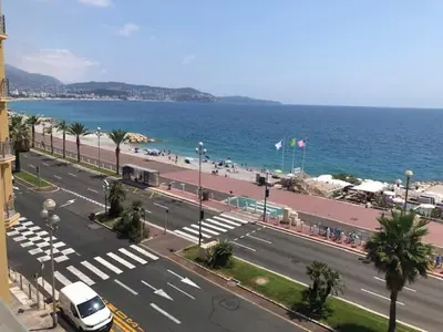 a view of a city with a street and the ocean at Eros in Nice