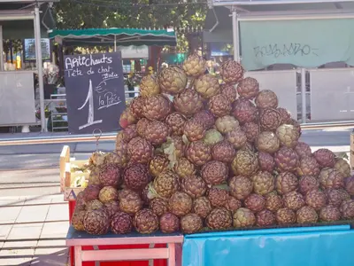 a pile of onions on a table in a market at Appartement proche de Libération avec balcon ensoleillé in Nice