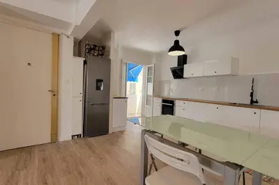 a kitchen with a glass counter top and a refrigerator at Apartment 3 pieces par la mer avec climatisation in Nice