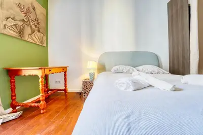 two twin beds in a room with a table and a bed at New vieille ville cimiez Centre Nice in Nice