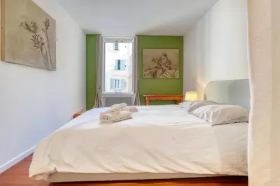 a bedroom with a white bed with a towel on it at New vieille ville cimiez Centre Nice in Nice