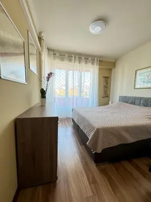 a bedroom with a bed and a vase of flowers at Magnifique 2 pièces à 2 pas de la mer in Nice