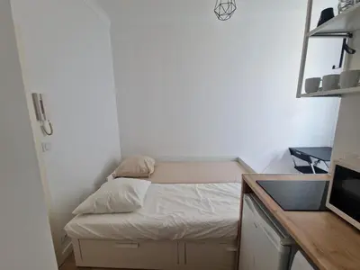 a small room with a bed and a sink at Studio Niçois Proche Mer in Nice
