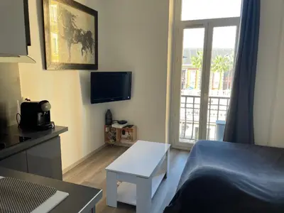 a small living room with a bed and a table at Superbe appartement en plein centre ville de Nice! in Nice