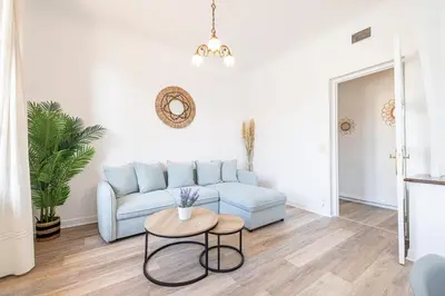 a living room with a blue couch and a table at Large Central 2 Bdr & Garage in Nice