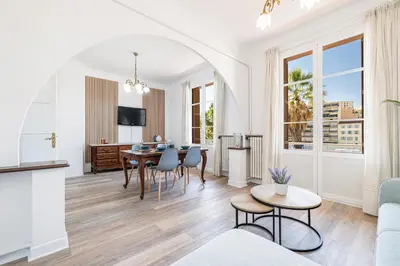 a living room with a table and chairs at Large Central 2 Bdr & Garage in Nice