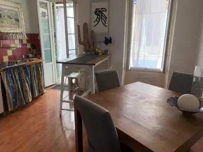 a dining room with a wooden table and chairs at Room near Nice Port in a shared apartment in Nice