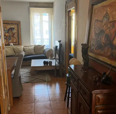 a living room with a couch and a table at Room for NUDISTS near Nice port in a shared apartment in Nice