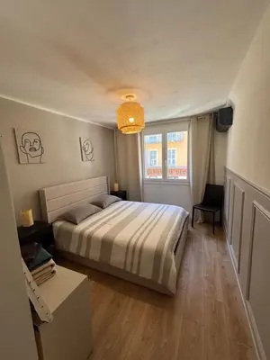 a bedroom with a bed and a window at Appartement confortable et cosy sur le port de Nice in Nice