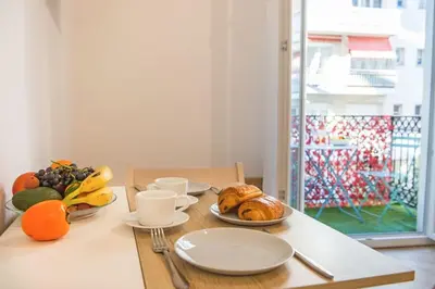a table with plates of food and fruit on it at - - Superbe Studio avec Balcon - Nice Centre - - in Nice