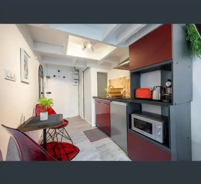 a small kitchen with a table and a microwave at Studio au coeur du centre ville de Nice in Nice