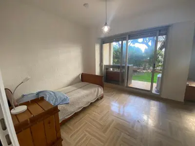 a bedroom with a bed and a large window at Cros de Cagnes Pins Sud Évasion in Cros-de-Cagnes