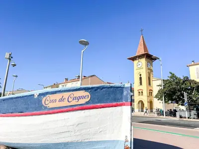 a building with a clock tower on a street at t3 cagnes sur mer in Cagnes-sur-Mer
