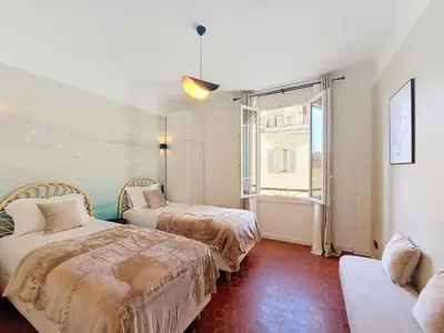 two beds in a room with a window and a couch at Nestor&Jeeves - FEI HOME - Port - Modern in Nice