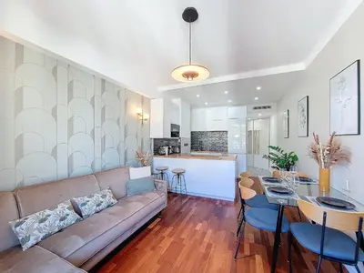 a living room and kitchen with a couch and a table at Nestor&Jeeves - FEI HOME - Port - Modern in Nice