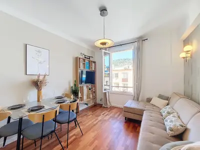 a living room with a table and a couch at Nestor&Jeeves - FEI HOME - Port - Modern in Nice