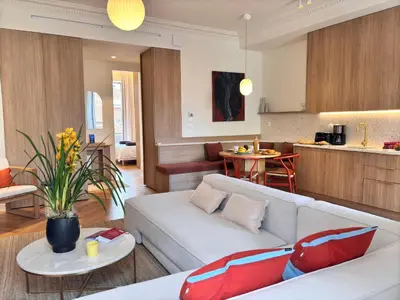 a living room with a white couch and a kitchen at Ze Perfect Place - Splendide Appart 2 Chb Garibaldi in Nice