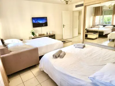 a bedroom with two beds and a mirror at Sunny Escape in Nice