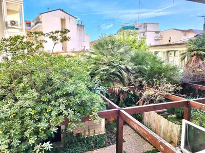 a wooden fence with trees and buildings in the background at Sunny Escape in Nice