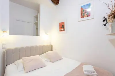 a bed with white sheets and pillows in a room at L59 Appartment La Loge Vieux Nice, central AC & WIFI in Nice