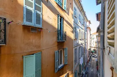 an alley with green shutters on a building at L59 Appartment La Loge Vieux Nice, central AC & WIFI in Nice