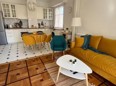a living room with a yellow couch and a table at Sunny Gambetta with 3 air conditionings in Nice