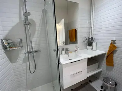 a white bathroom with a sink and a shower at Sunny Gambetta with 3 air conditionings in Nice