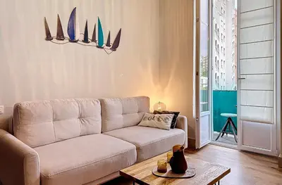 a living room with a couch and a table at Charming 2-Bedroom Retreat Near City Center with Excellent Transport Links in Nice