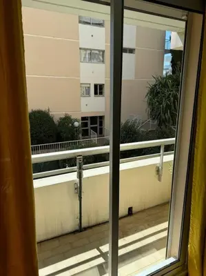 a view of a balcony from a window of a building at Studio proche mer - Climatisé in Cagnes-sur-Mer