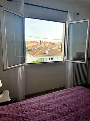 a bedroom with two large windows and a purple bed at Charmant T3 Rénové Proche Mer, Aéroport et Gare ! in Saint-Laurent-du-Var
