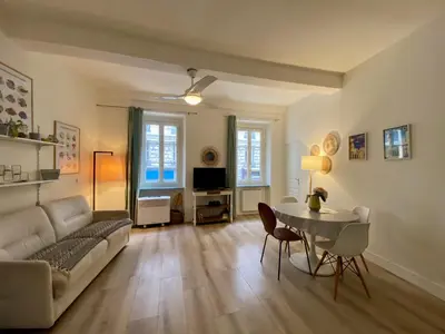 a living room with a couch and a table at Joli appartement niçois en bord de mer in Nice