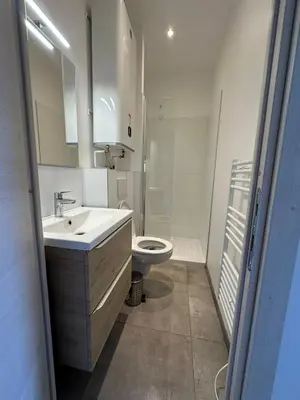 a white bathroom with a sink and a toilet at Ete Nice in Nice